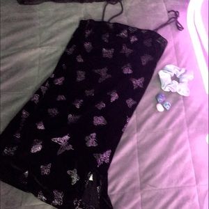 Black mini dress with silver sparkly butterflies and mini split on thigh